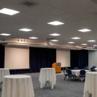 A view of the Grand River Room with standing tables and seated tables.